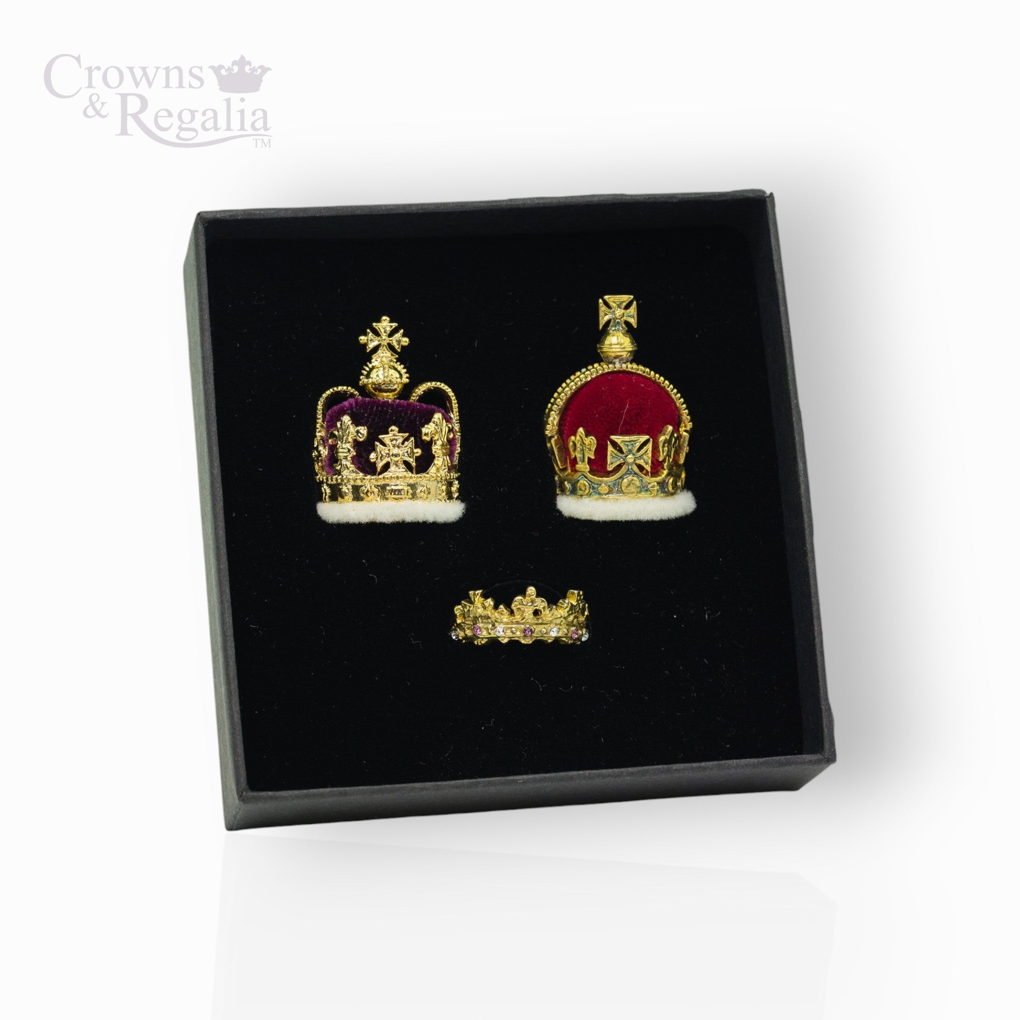 Crown-shaped earrings in a black box with 'Crowns & Regalia' branding.