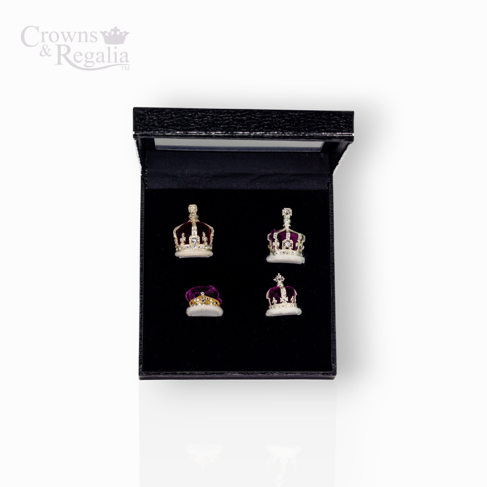 Set of crown-shaped earrings in a black display box with 'Crowns & Regalia' branding.