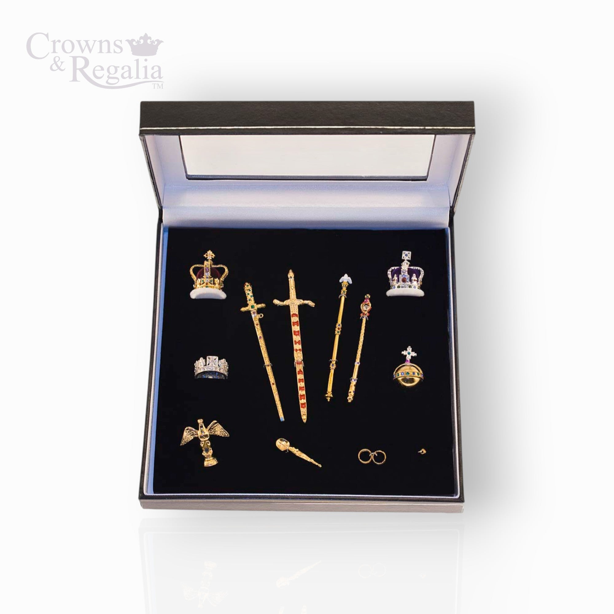 Set of decorative items including crowns and swords in a 'Crowns & Regalia' box on a white background.