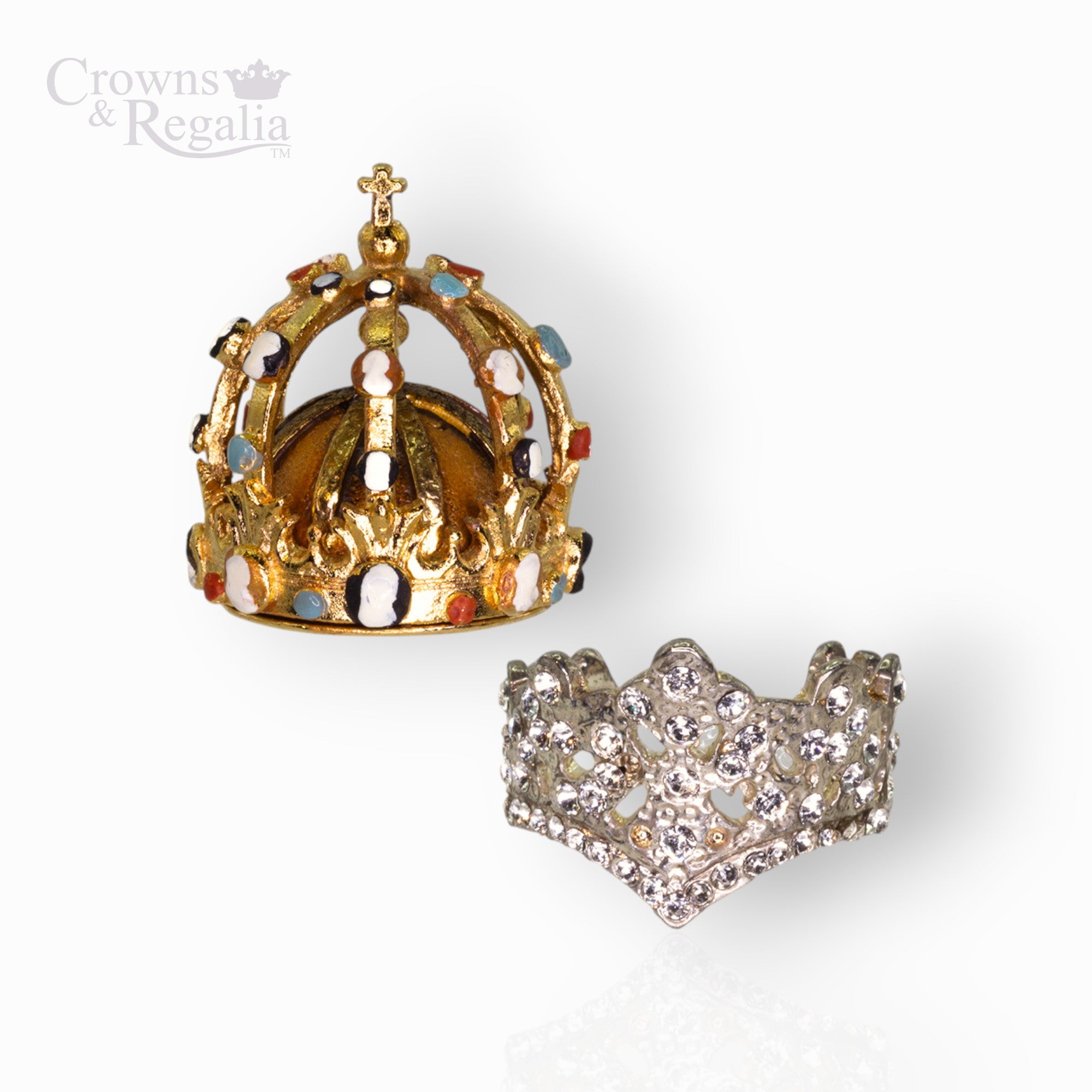Gold crown with gemstones and silver crown-shaped ring on a white background, branded 'Crowns & Regalia'.