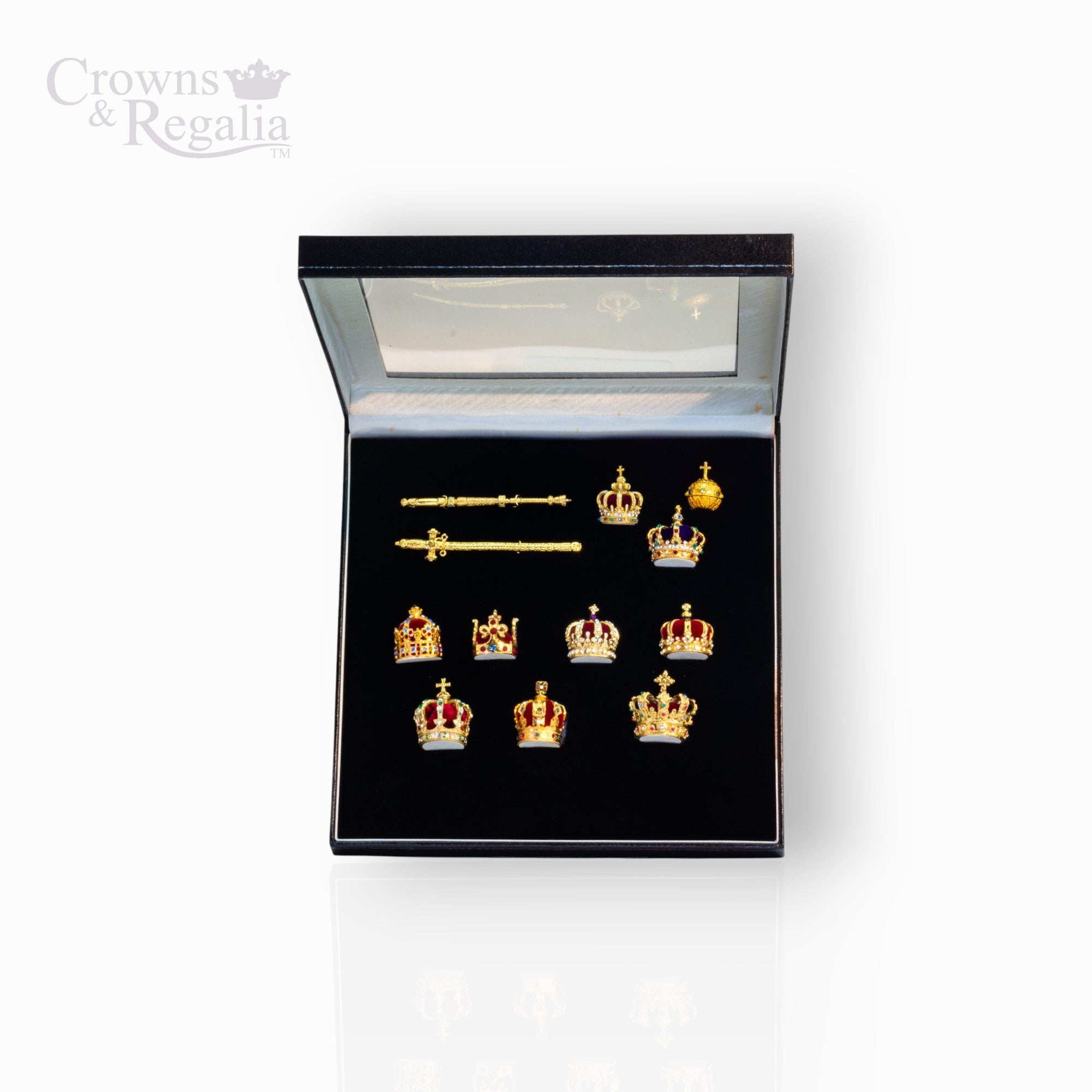 Set of gold crown-shaped jewelry in a black display box with 'Crowns & Regalia' branding.