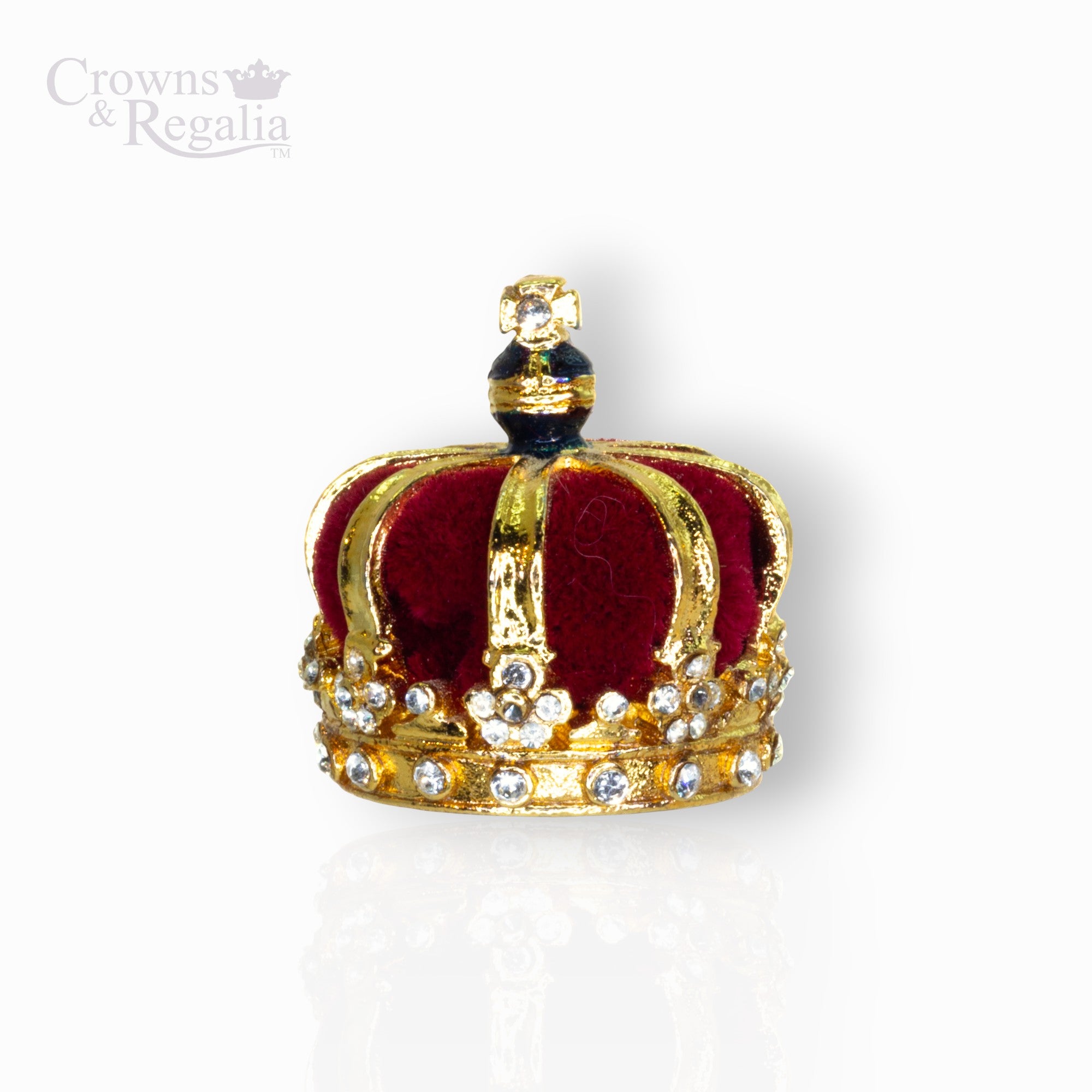 Gold crown with red center and gemstones on a white background, branded 'Crowns & Regalia'.