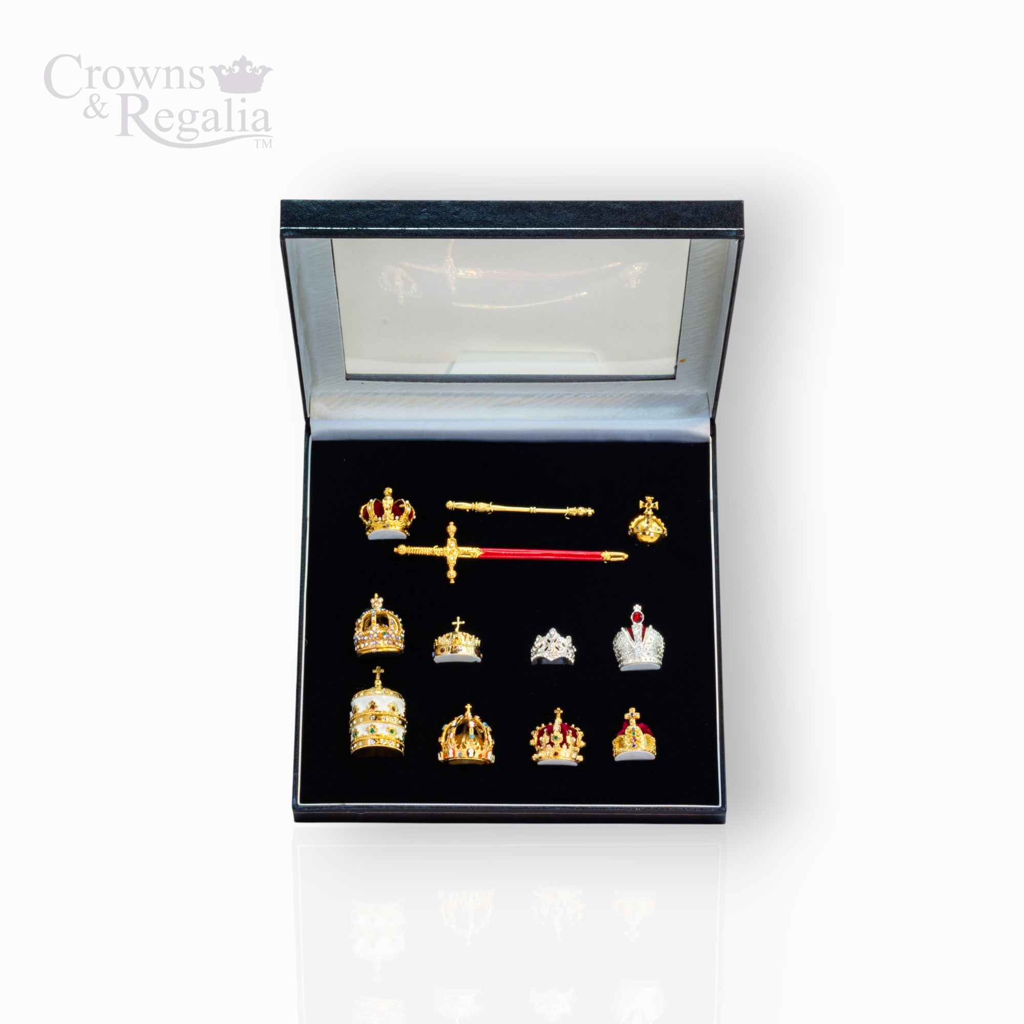 Collection of crowns and a sword in a display box with 'Crowns & Regalia' branding.