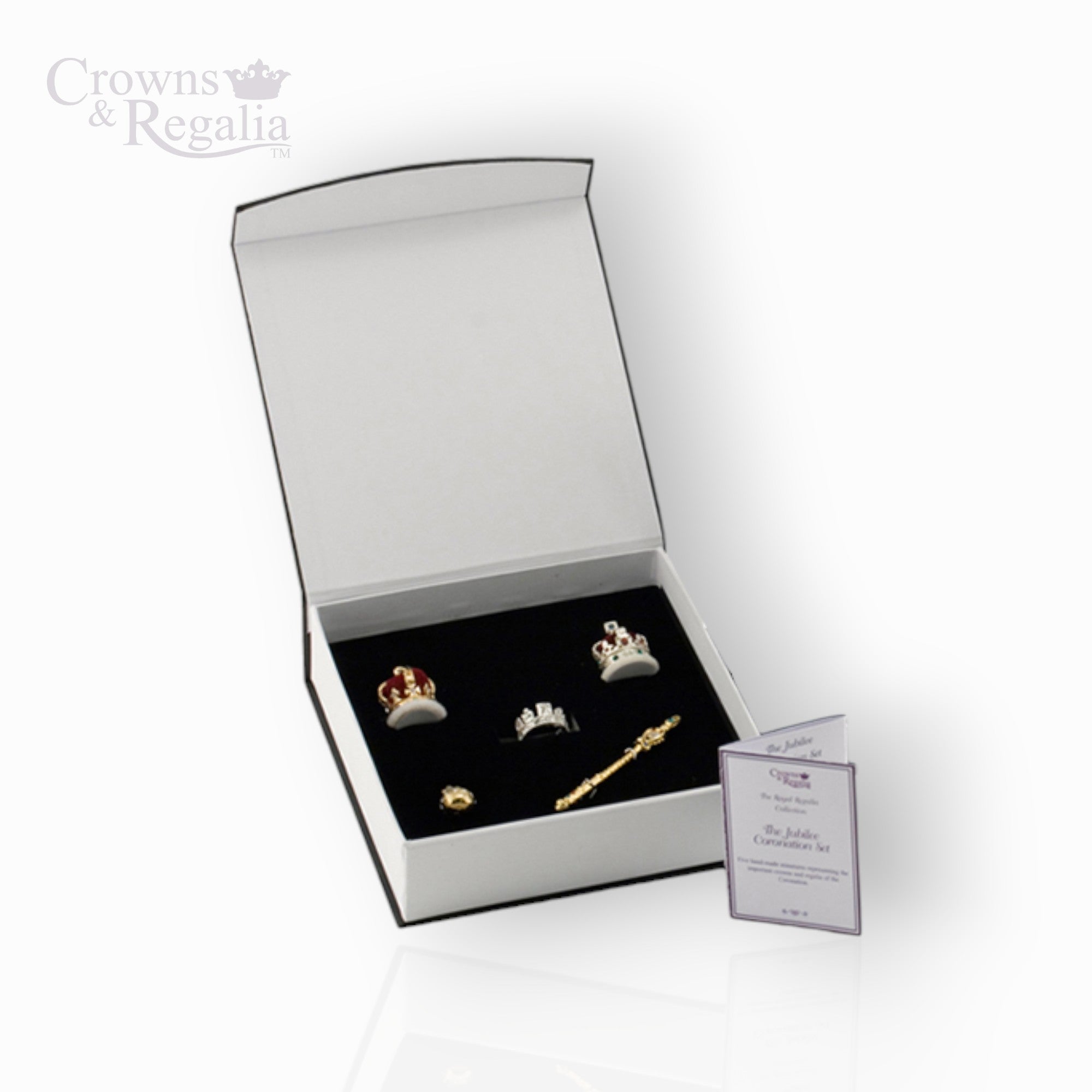 Jewelry set with tiaras and a scepter in a 'Crowns & Regalia' box on a white background