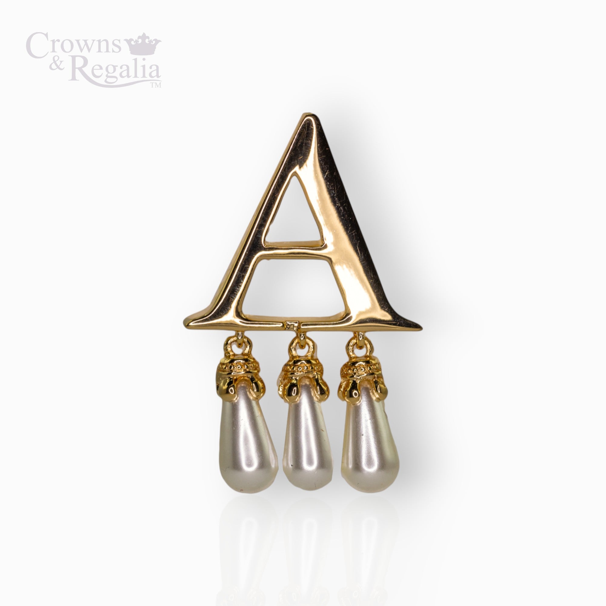 Gold brooch with 'A' and pearl drops on a white background, branded 'Crowns & Regalia'.