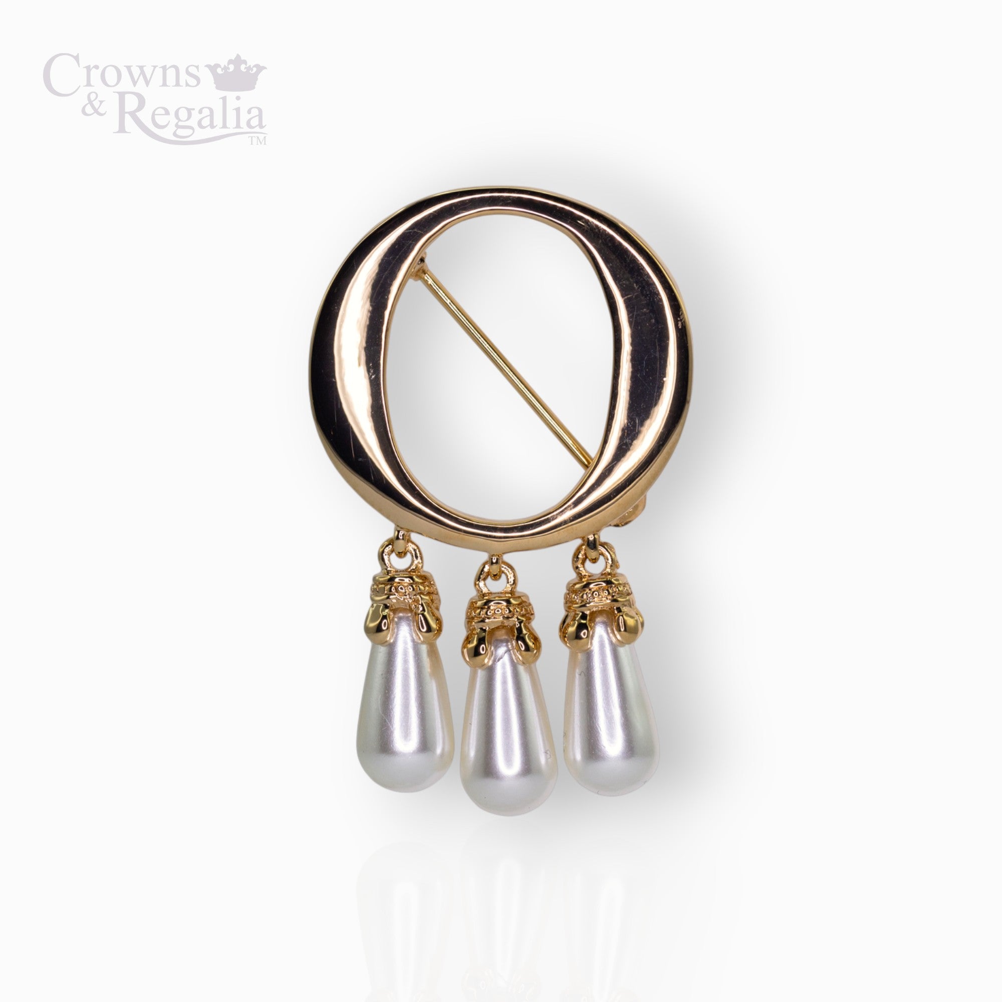 Gold brooch with 'O' pearl drops on a white background, branded 'Crowns & Regalia'.