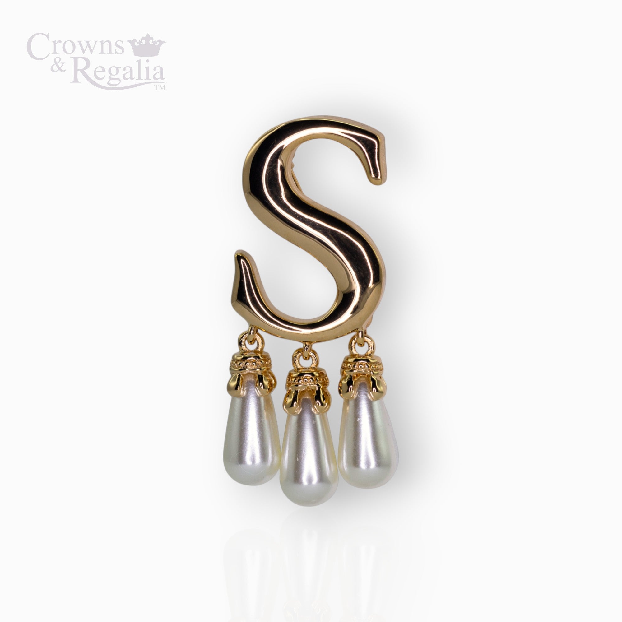 Gold brooch with 'S' design and pearl-like droplets on a white background, branded 'Crowns & Regalia'.