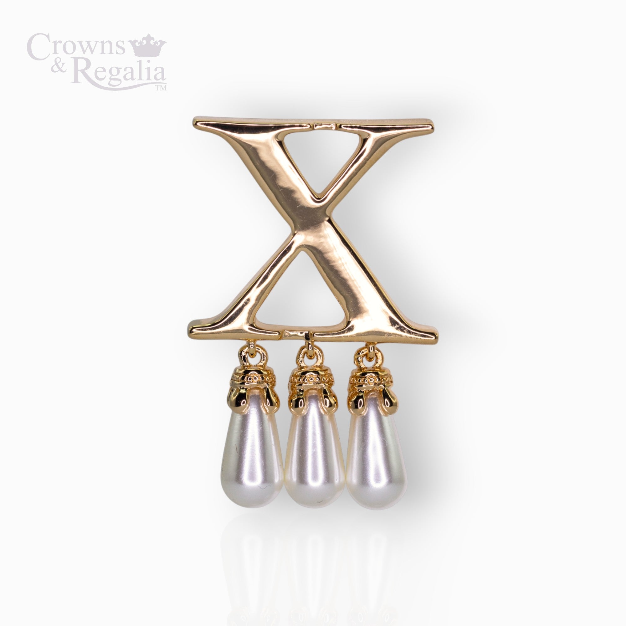 Gold brooch with 'X' design and pearl-like droplets on a white background, branded 'Crowns & Regalia'.
