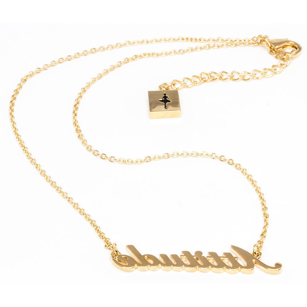 Gold necklace with 'Attitude' pendant on a white background