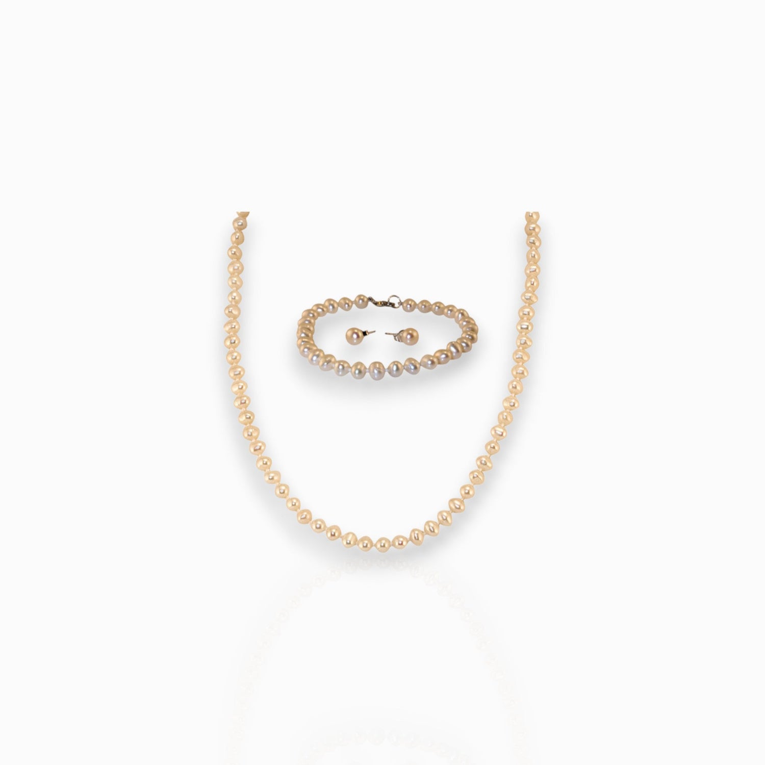 Small Pearl Necklace, Bracelet and Single Pearl -Earrings on a white background.