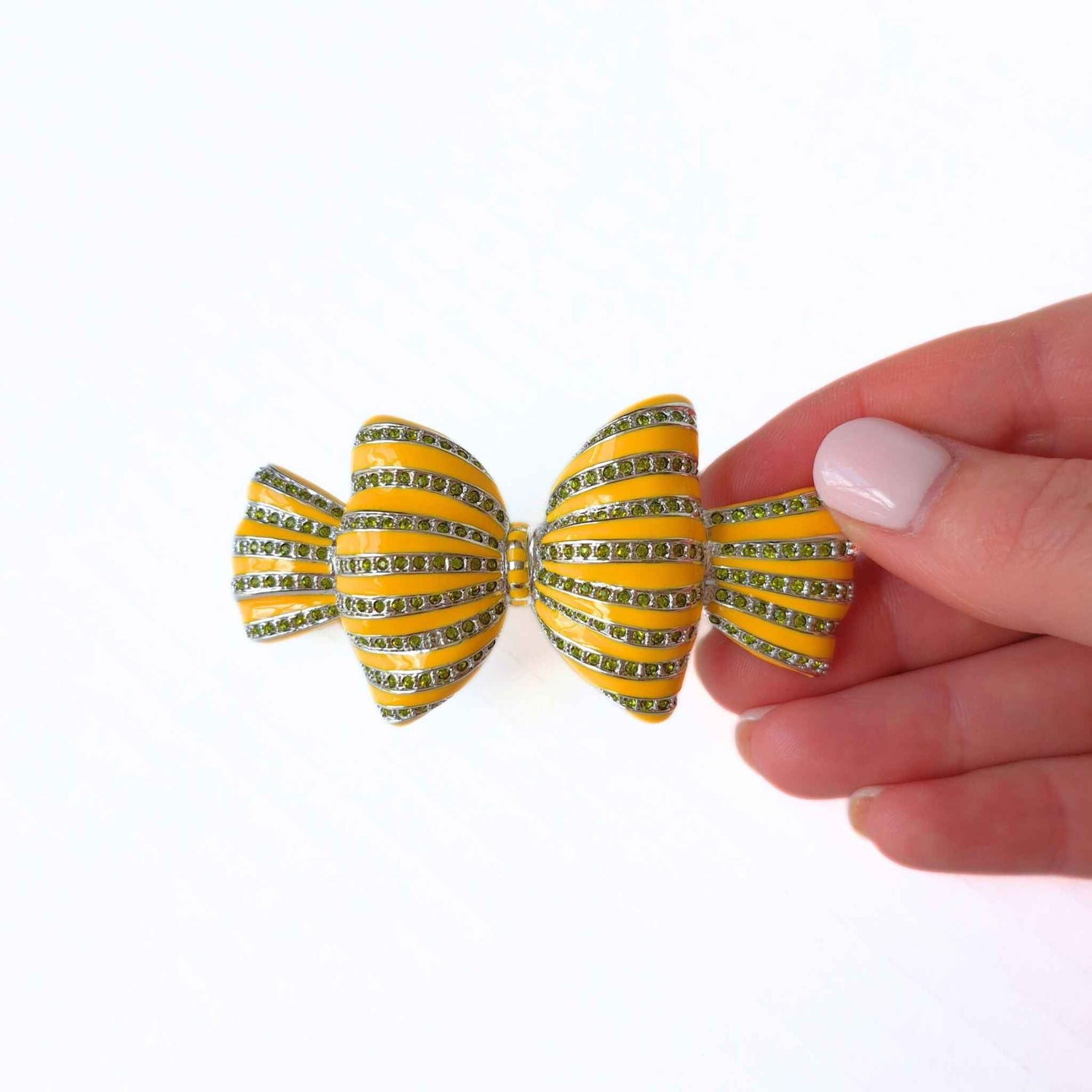 Bow Yellow Enamel and Crystal Hair Clip with hand pictured for scale