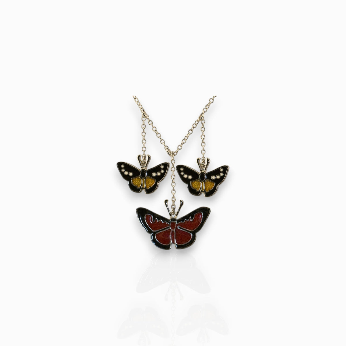 Flying Beauties Trio - Pendant on a white background.