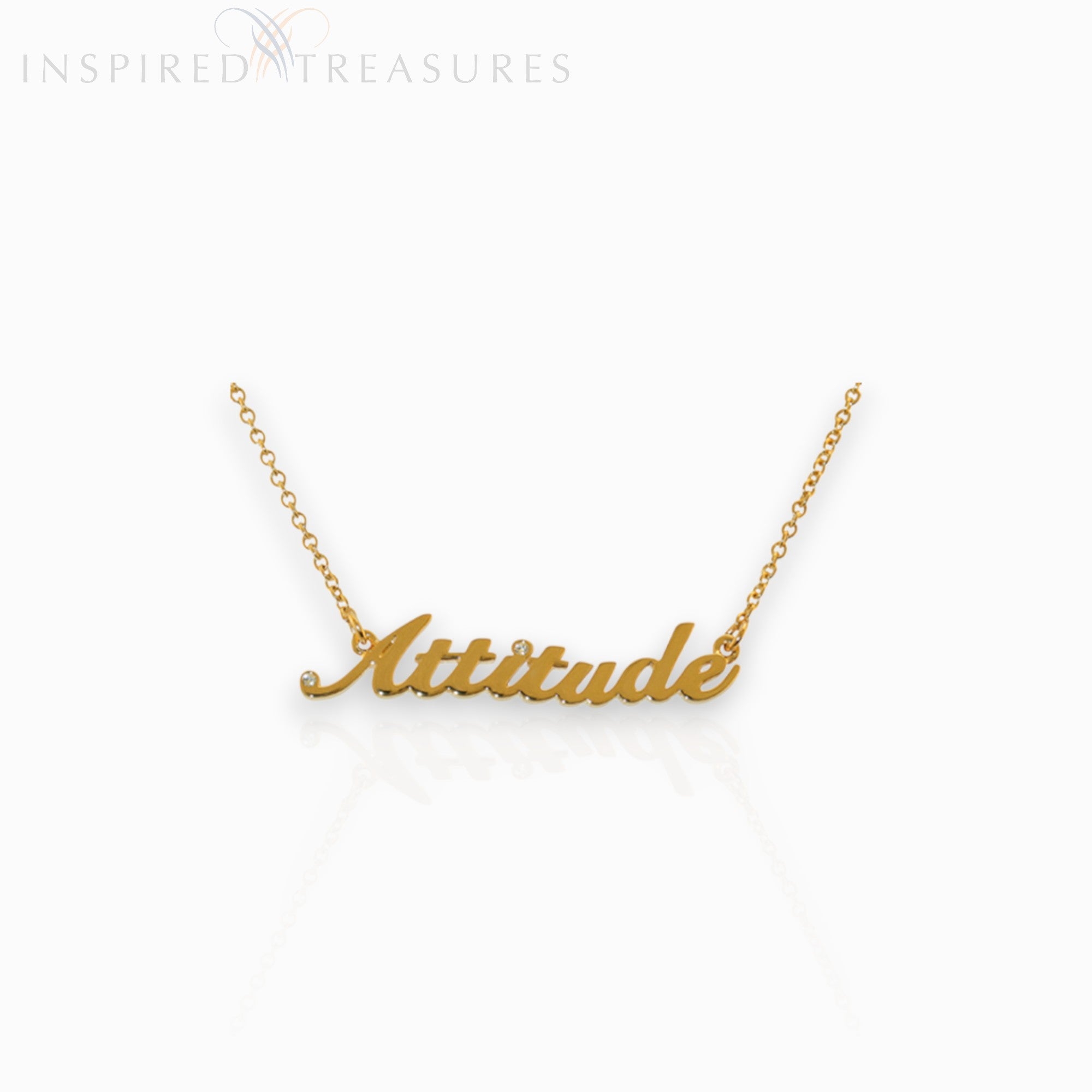 Gold necklace with 'Attitude' pendant on a white background