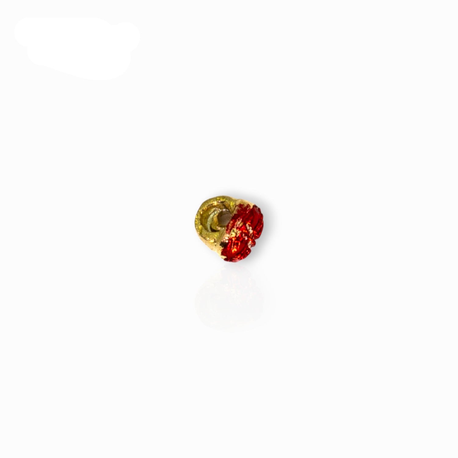 Small red and gold decorative item on a white background.