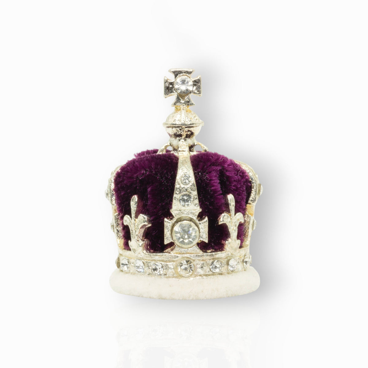 Silver crown with red center and gemstones on a white background.