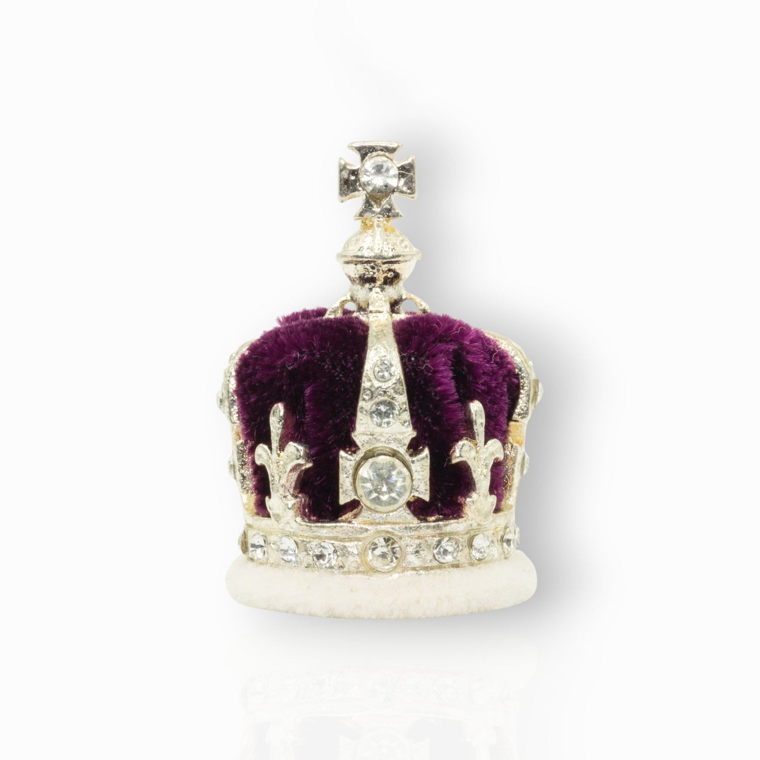 Silver crown with red center and gemstones on a white background.