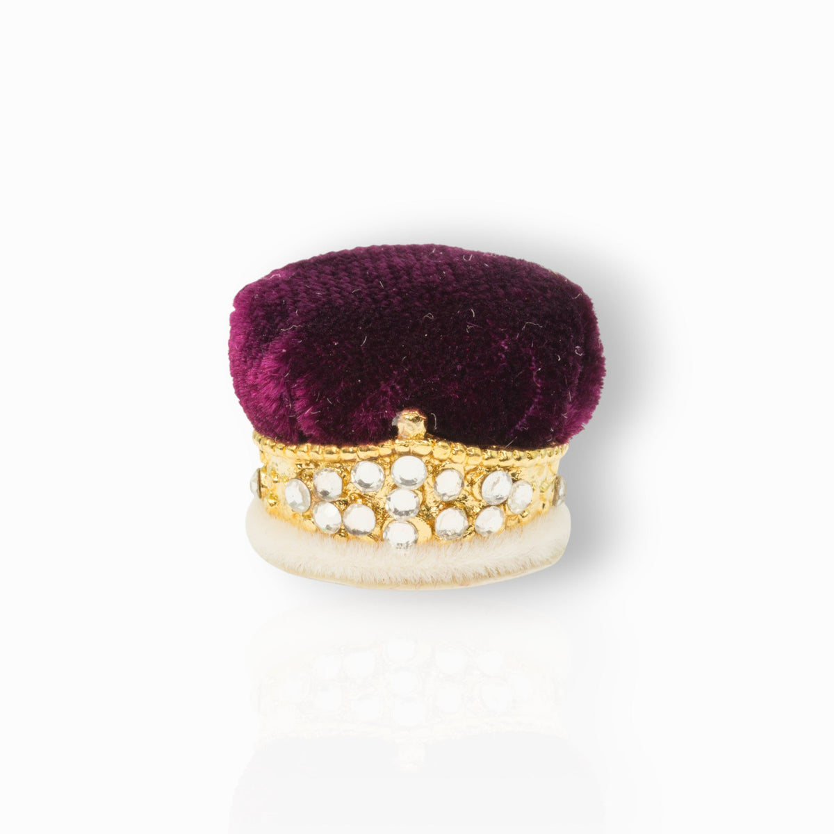 Purple velvet box with gold and white embellishments on a white background.