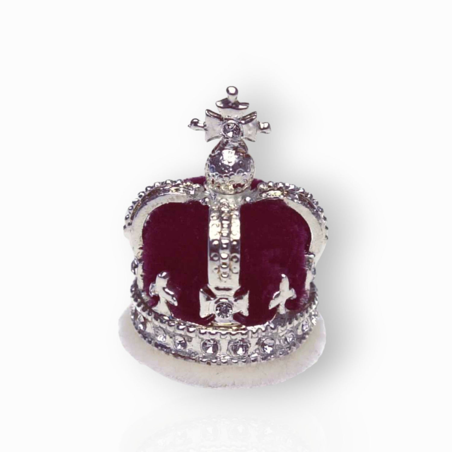 Decorative crown with red velvet and silver accents on a white background.