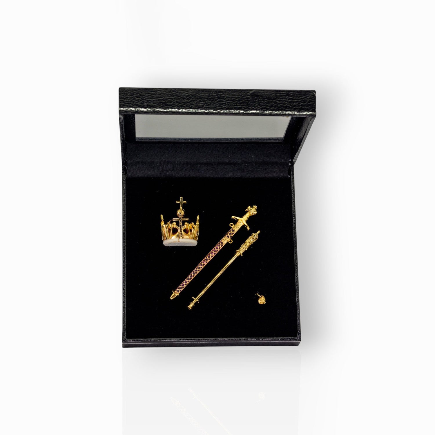 Gold crown and scepters in a black display box.