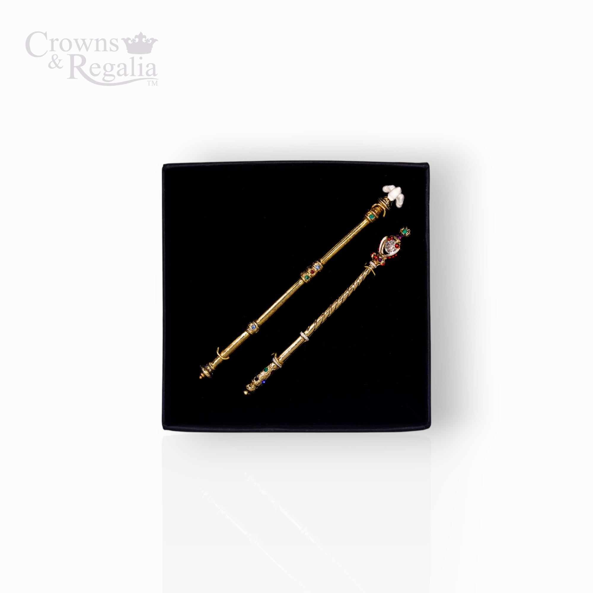 Two decorative sceptres on a black display box with 'Crowns & Regalia' branding.
