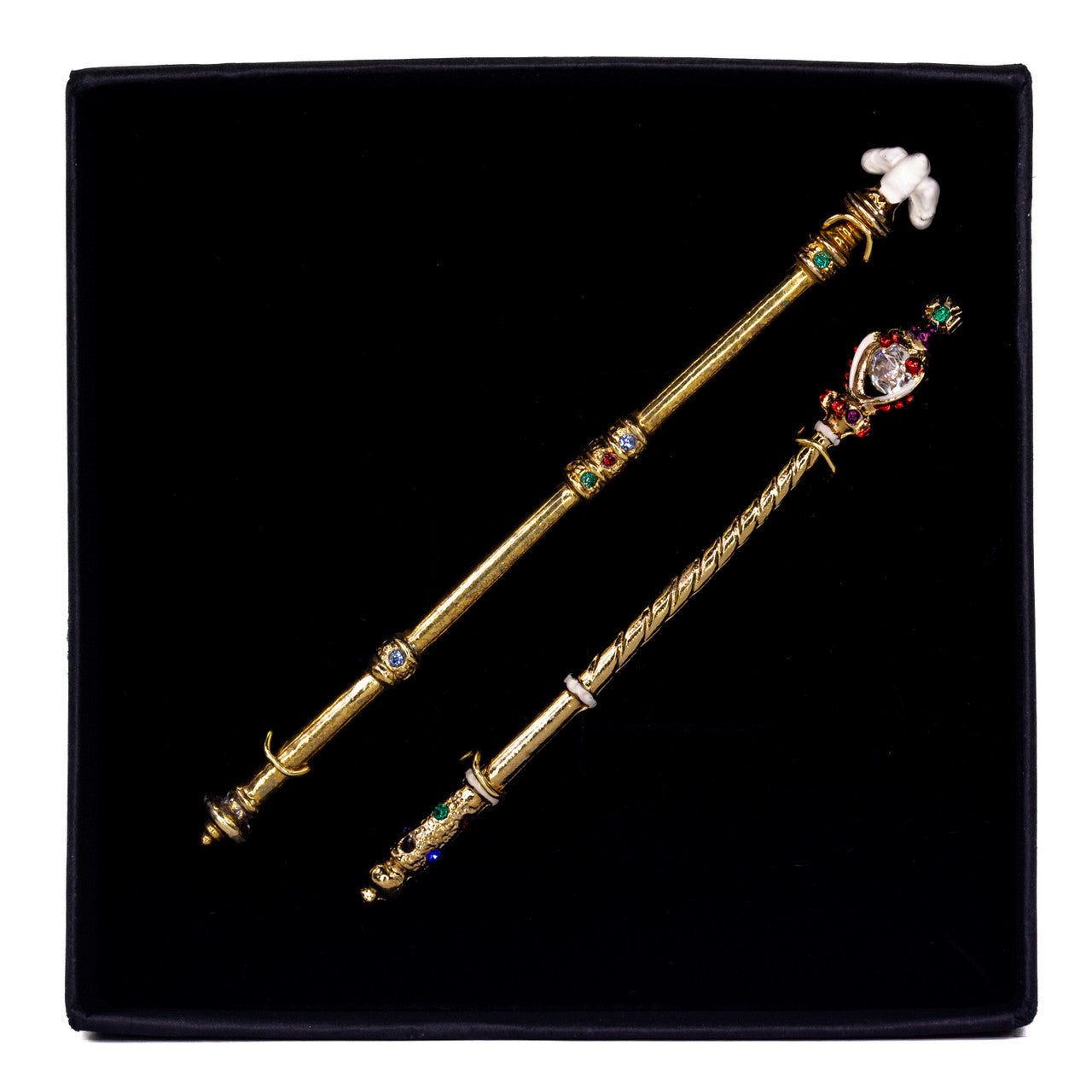 Miniature Regalia - The Coronation Sceptres on a white background.