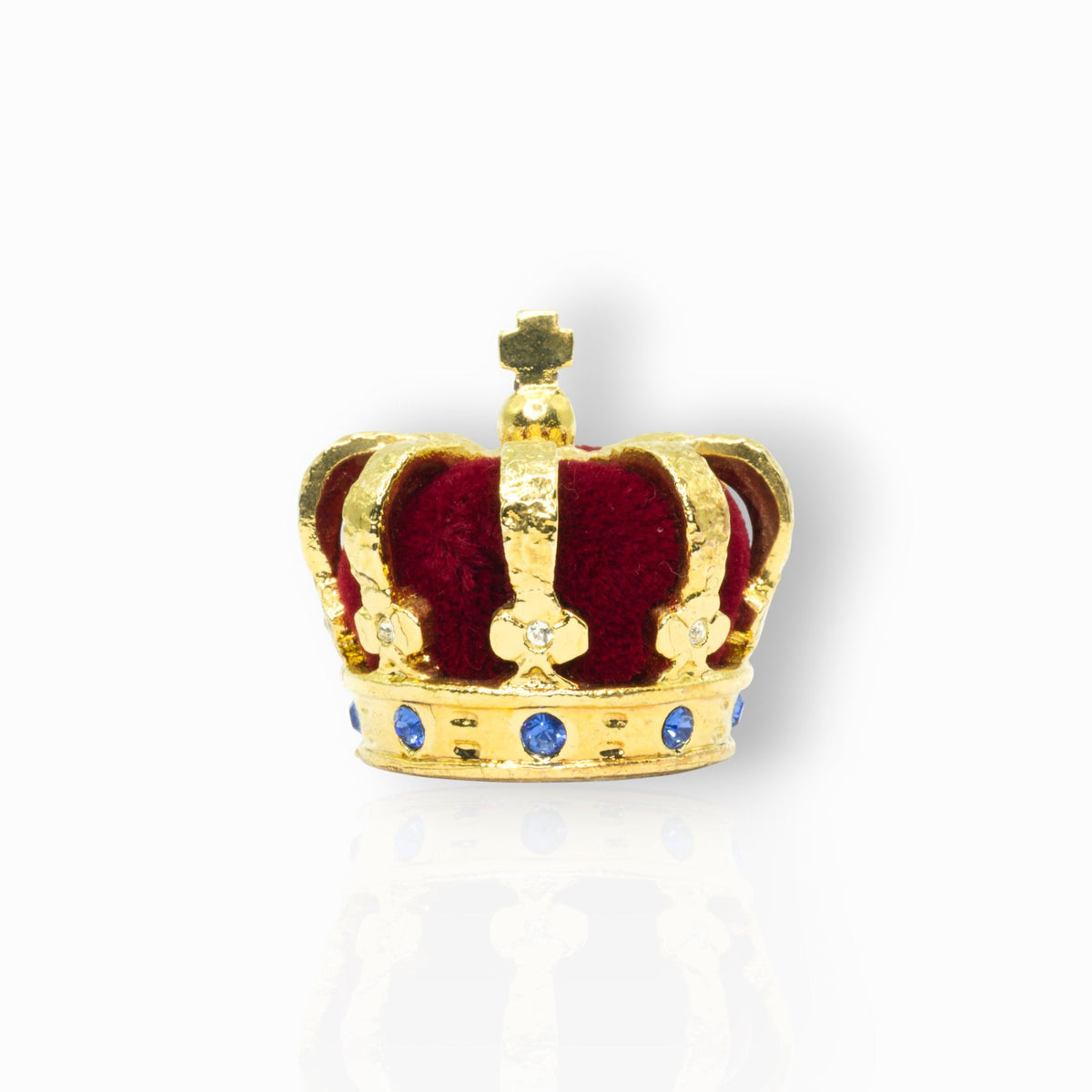 Gold crown with red velvet interior and blue stones on a white background.