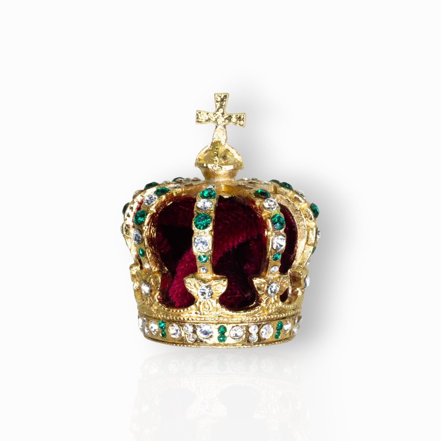 Gold crown with red velvet interior and green gemstones on a white background.