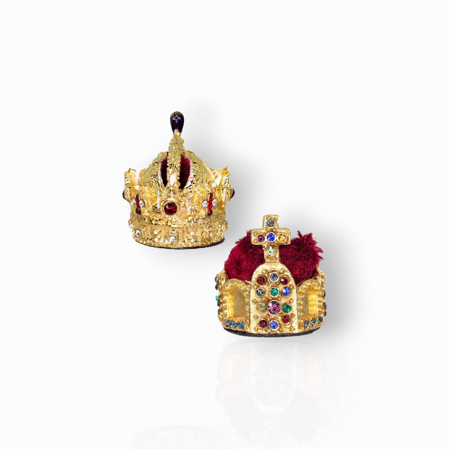 Two ornate gold crowns with gemstones on a white background.