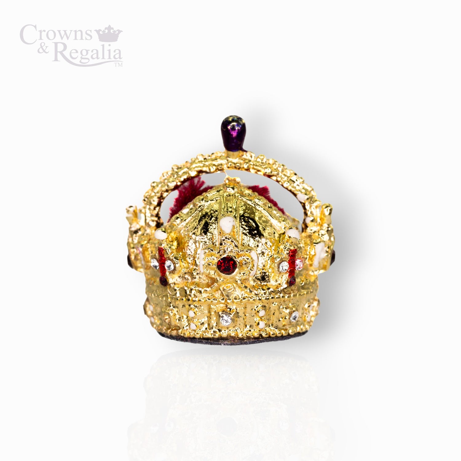 Gold crown with red stones on a white background.