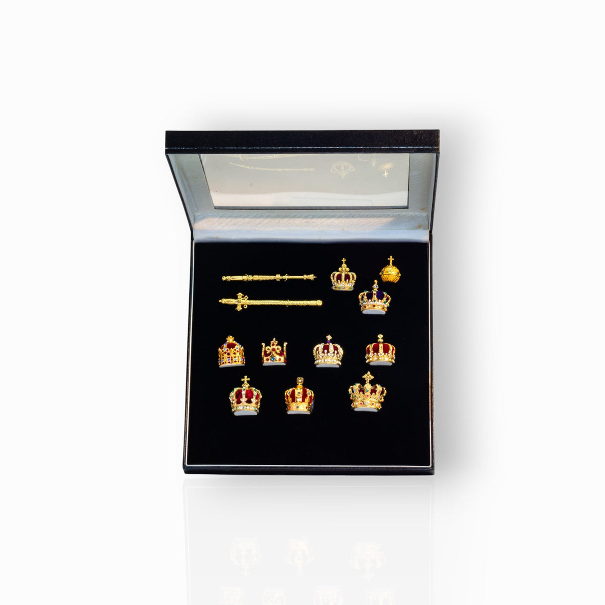 Set of gold crown-shaped jewelry in a black display box.