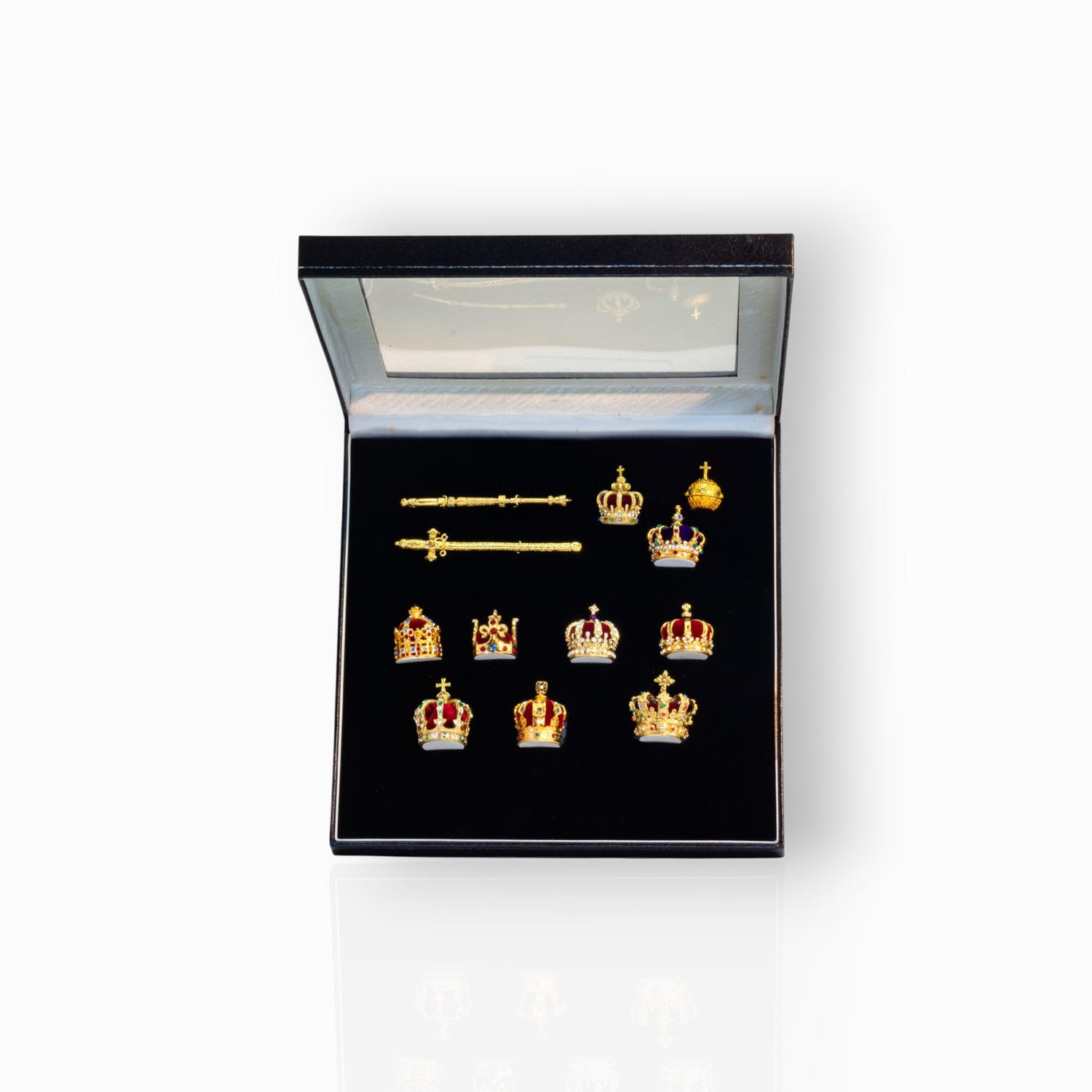 Set of gold crown-shaped jewelry in a black display box.