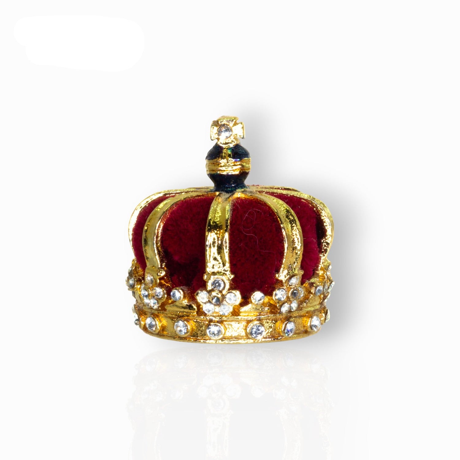 Gold crown with red center and gemstones on a white background.