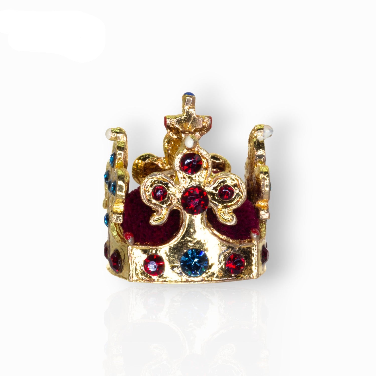 Gold crown with red and blue gemstones on a white background.