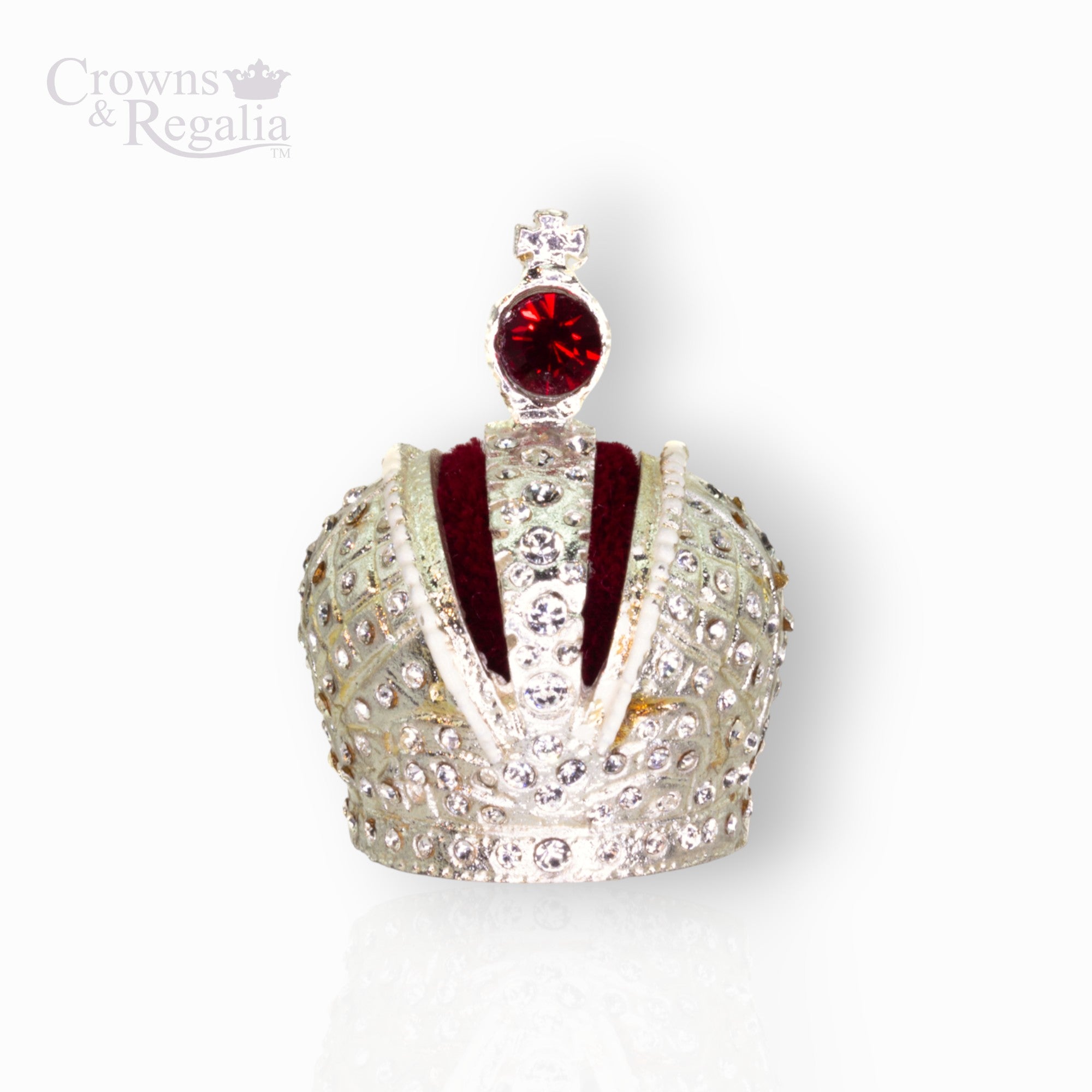 Decorative miniature crown with red gemstone on a white background, branded 'Crowns & Regalia'.