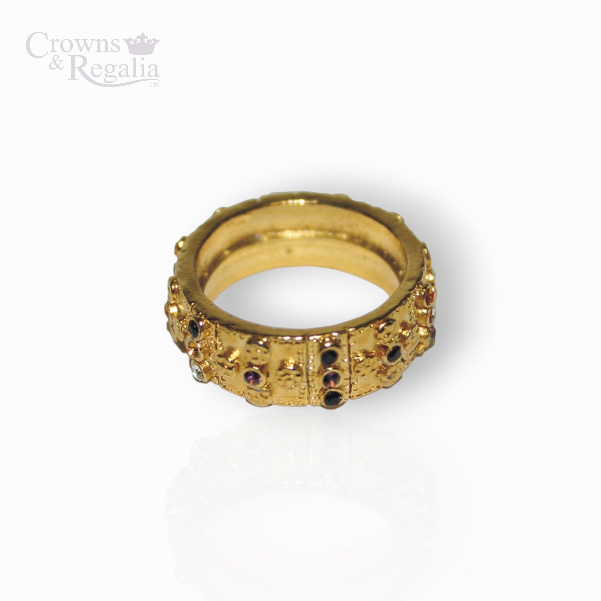 Gold ring with gemstones on a white background, branded 'Crowns & Regalia'.