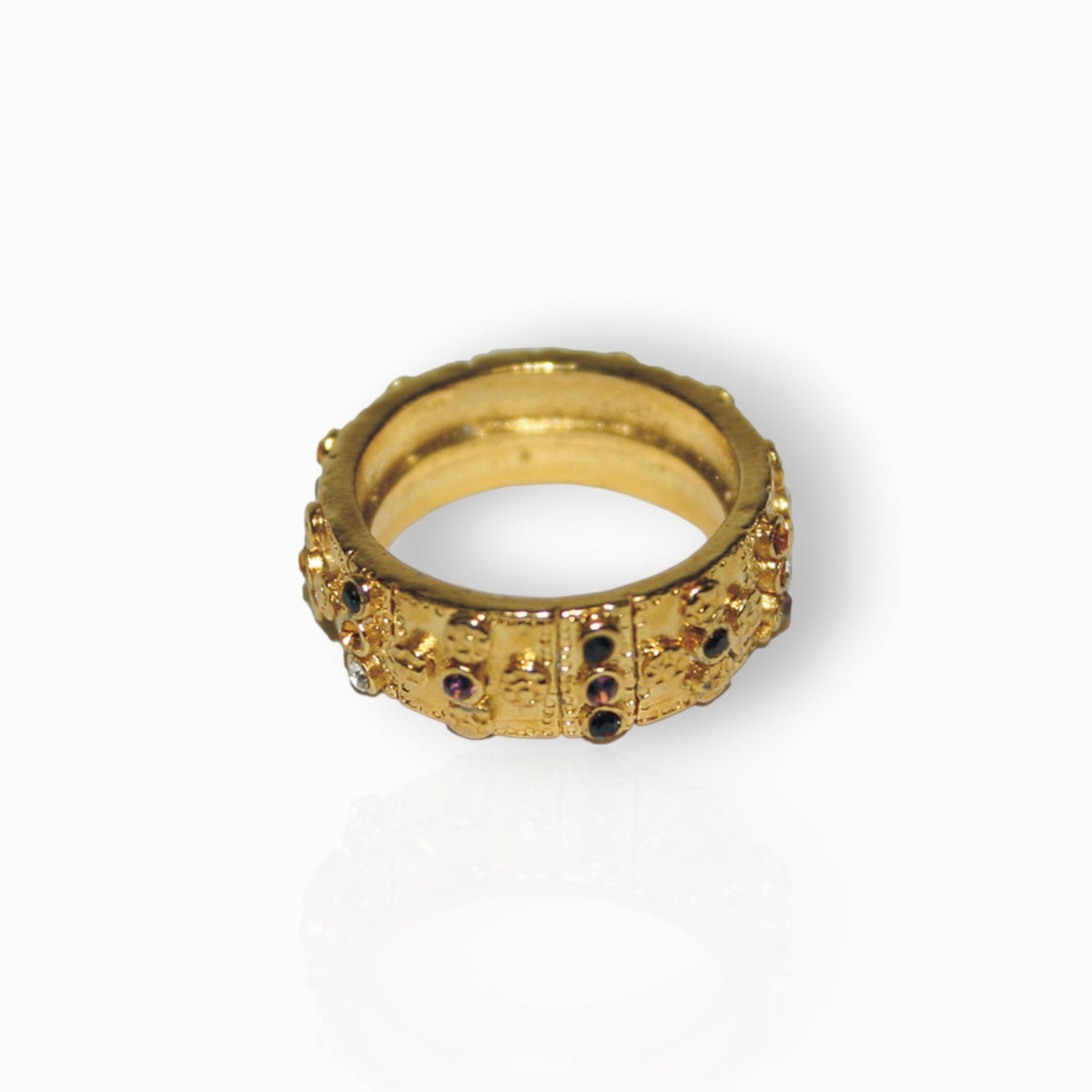 Gold ring with gemstones on a white background.