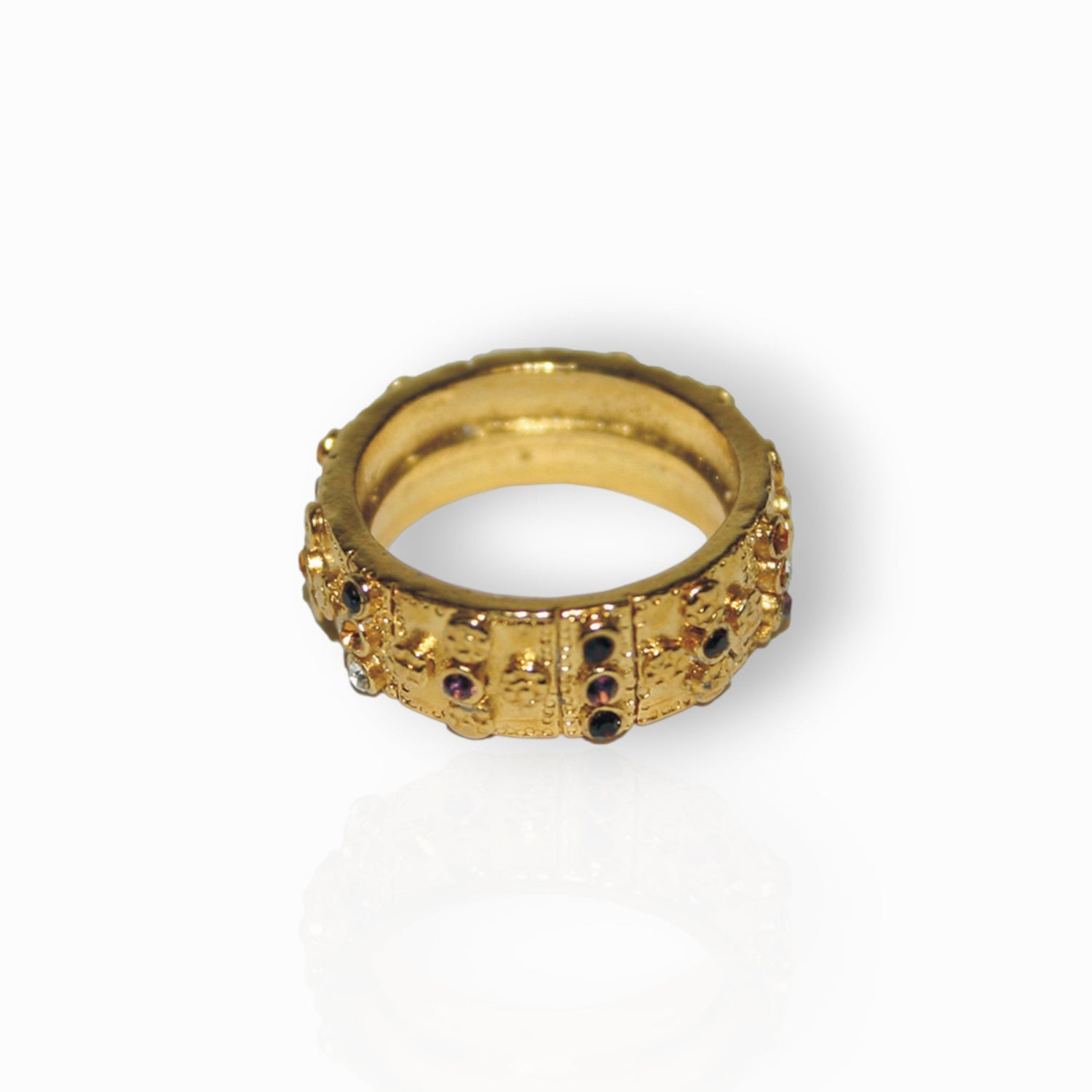 Gold ring with gemstones on a white background.