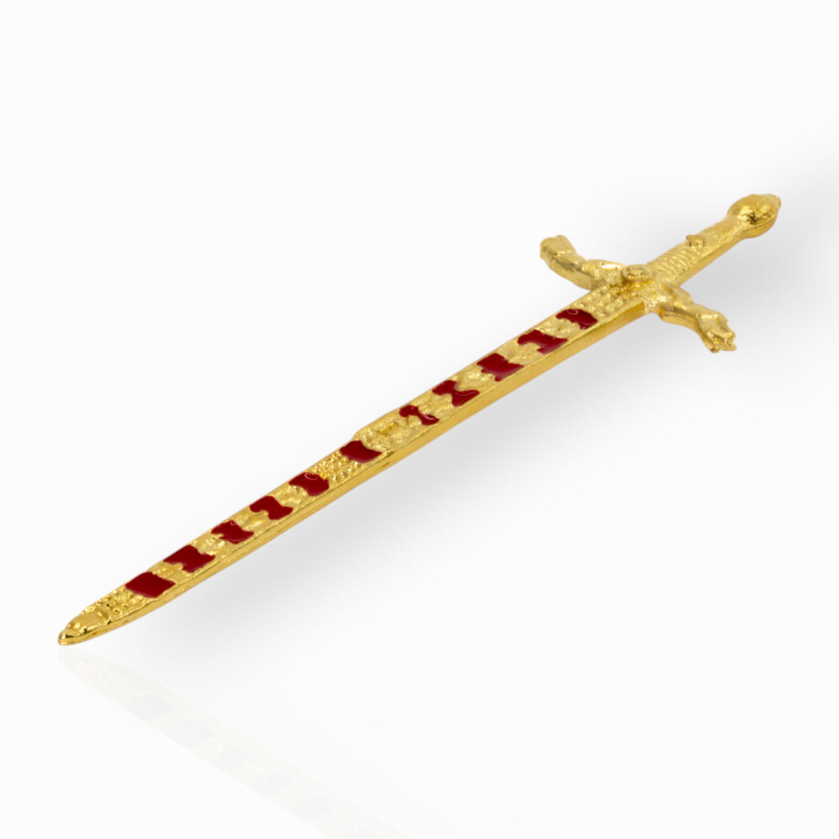 Decorative gold sword with red enamel on a white background.