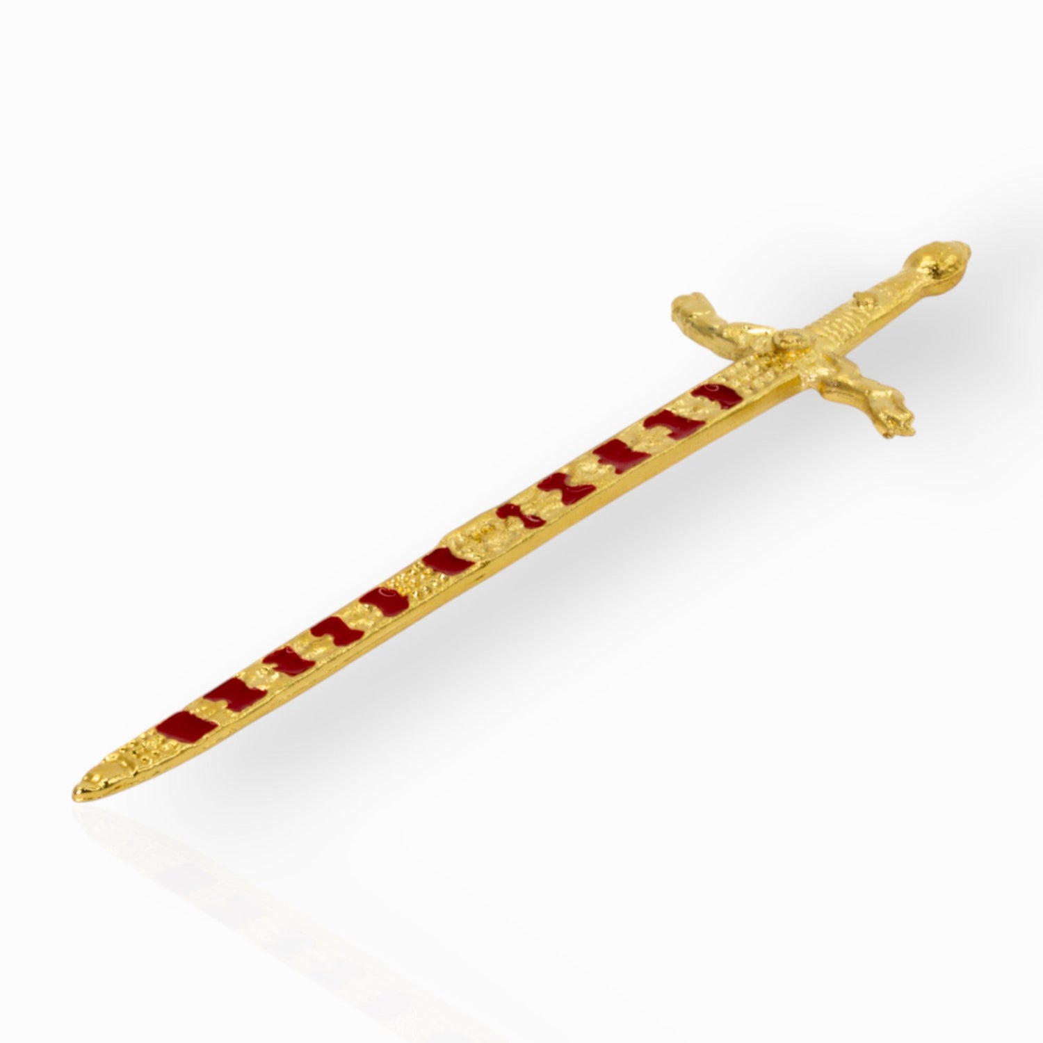 Decorative gold sword with red enamel on a white background.