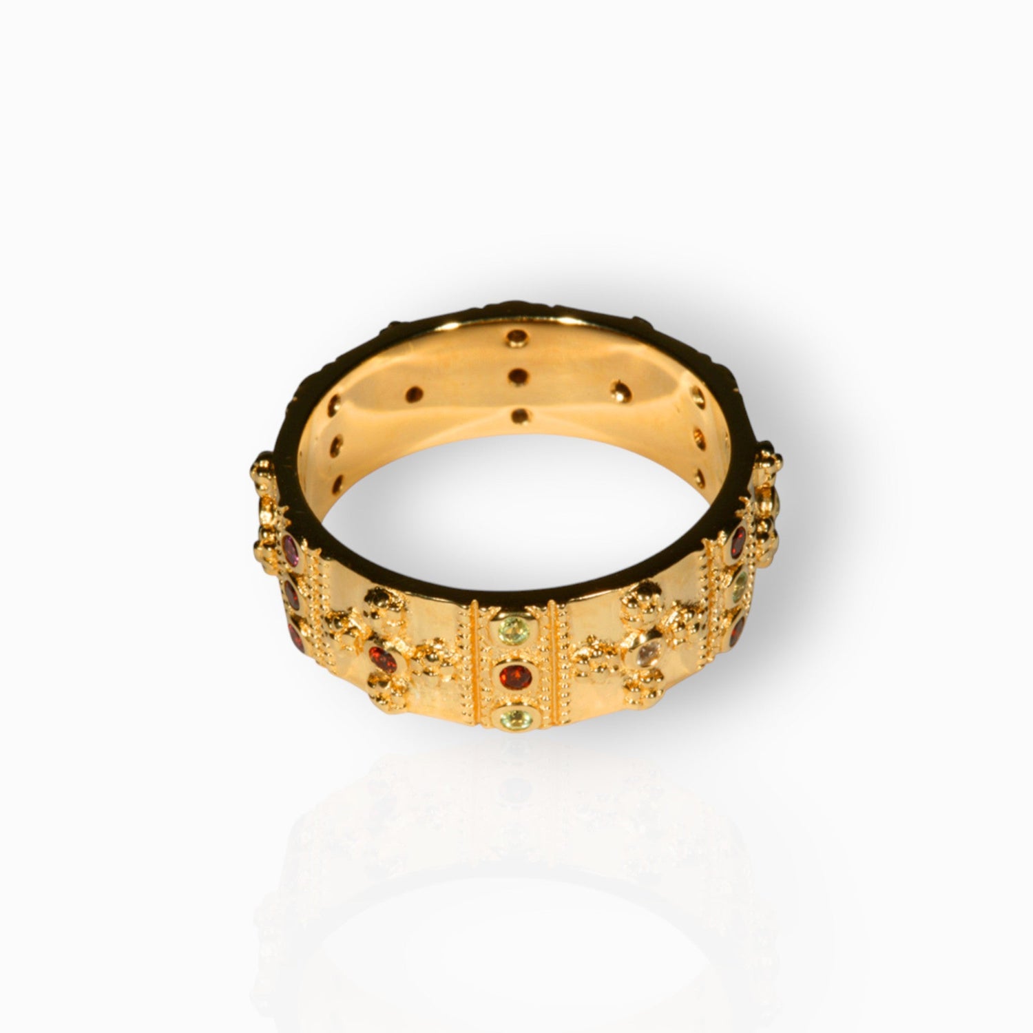 Gold ring with gemstones on a white background.