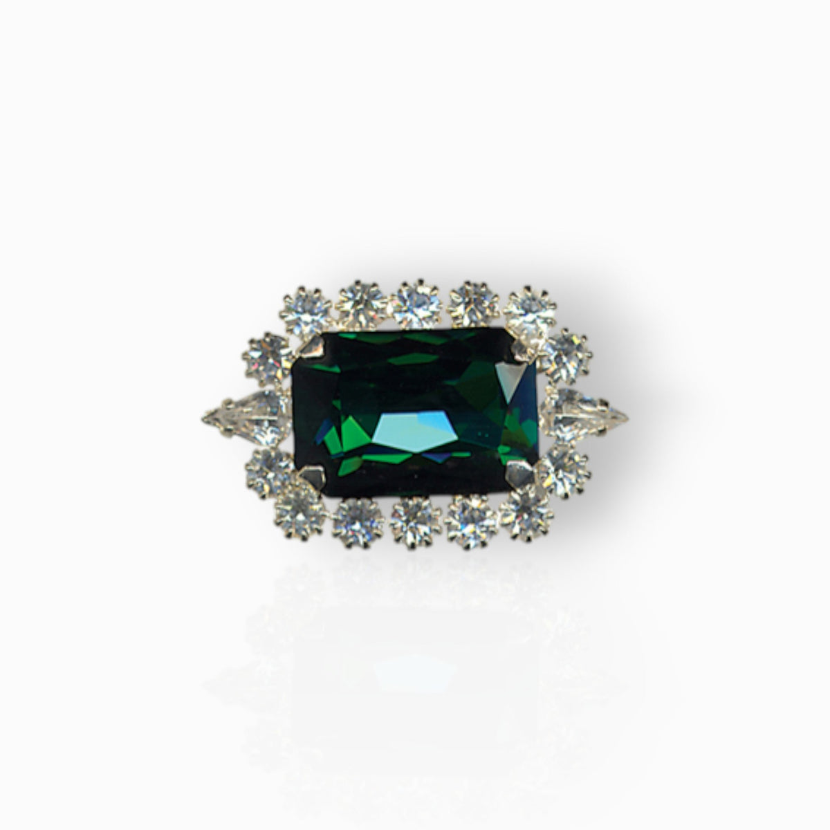 The British Crown Of India Emerald - Brooch on a white background.
