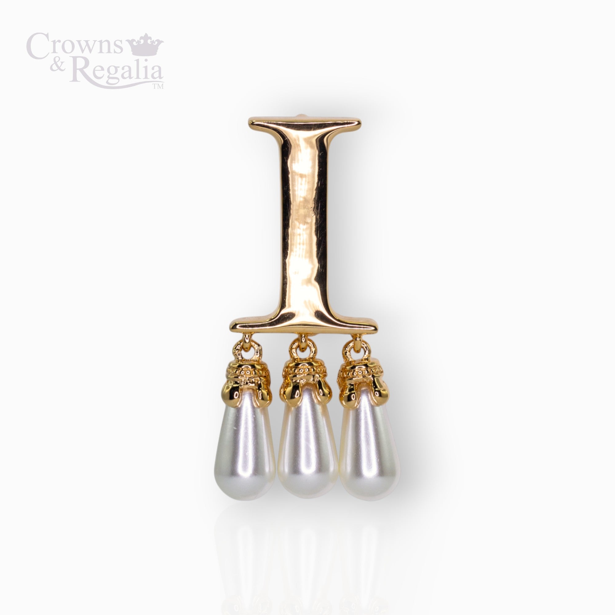 Gold brooch with 'I' and three pearl drops on a white background, branded 'Crowns & Regalia'.