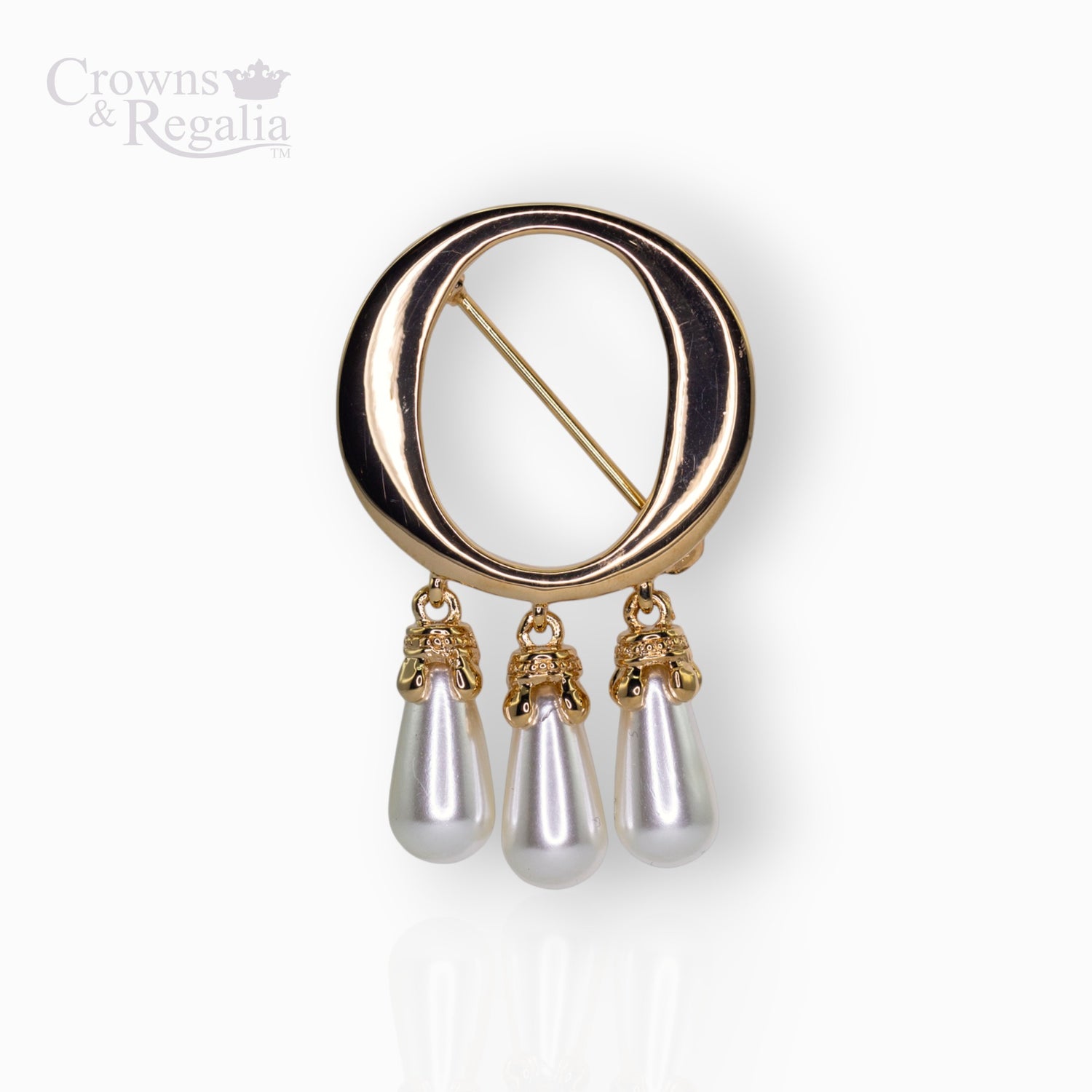 Gold brooch with 'O' pearl drops on a white background.