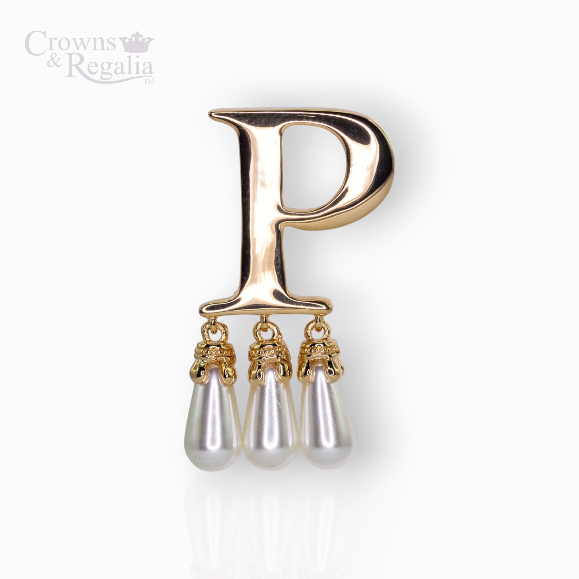 Gold brooch with letter 'P' and pearl-like droplets on a white background, branded 'Crowns & Regalia'.