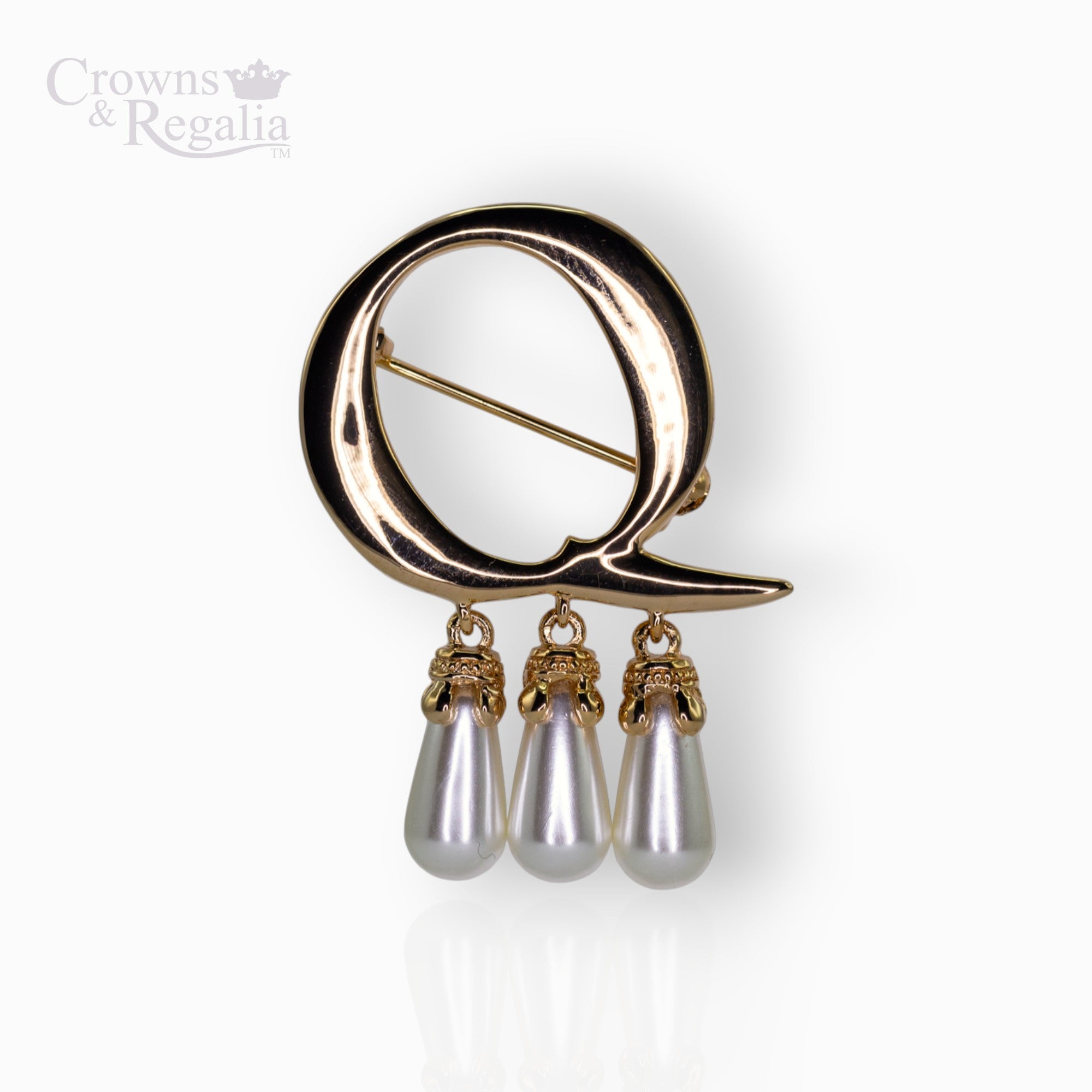 Gold brooch with 'Q' and pearl drops on a white background, branded 'Crowns & Regalia'.