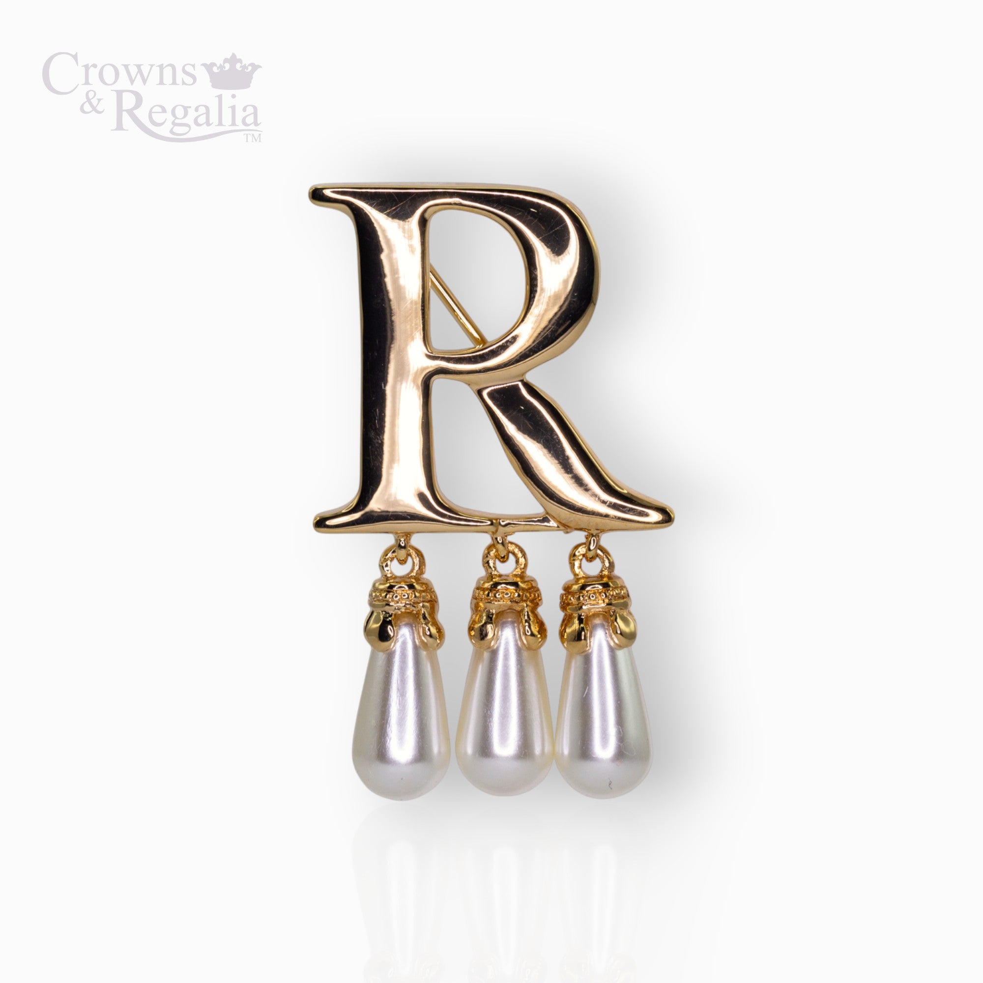 Gold brooch with letter 'R' and pearl drops on a white background, branded 'Crowns & Regalia'.