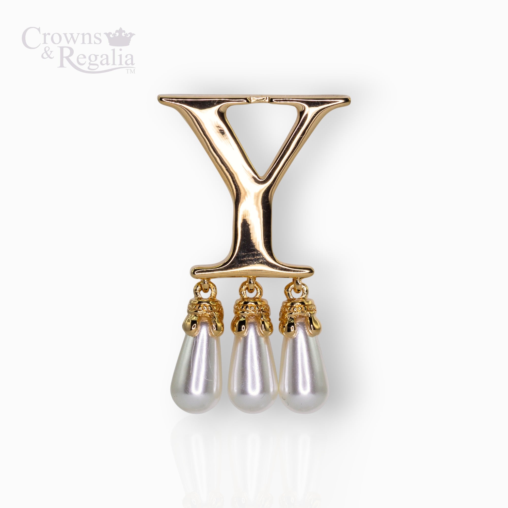 Gold brooch with 'Y' and three pearl drops on a white background, branded 'Crowns & Regalia'.
