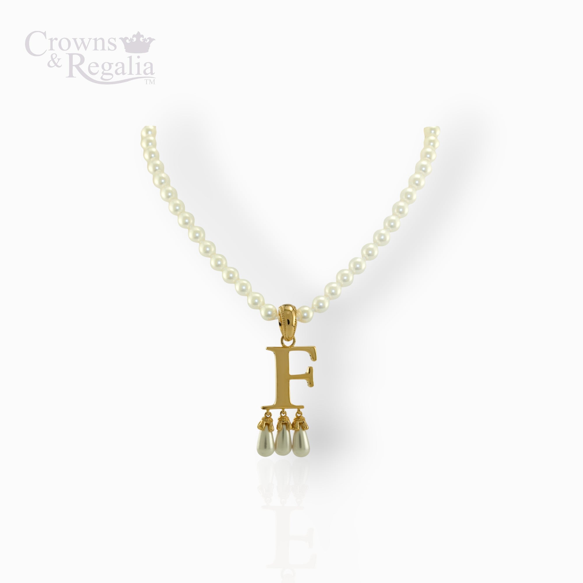 Pearl necklace with a gold pendant featuring the letter 'F' on a white background, branded 'Crowns & Regalia'.