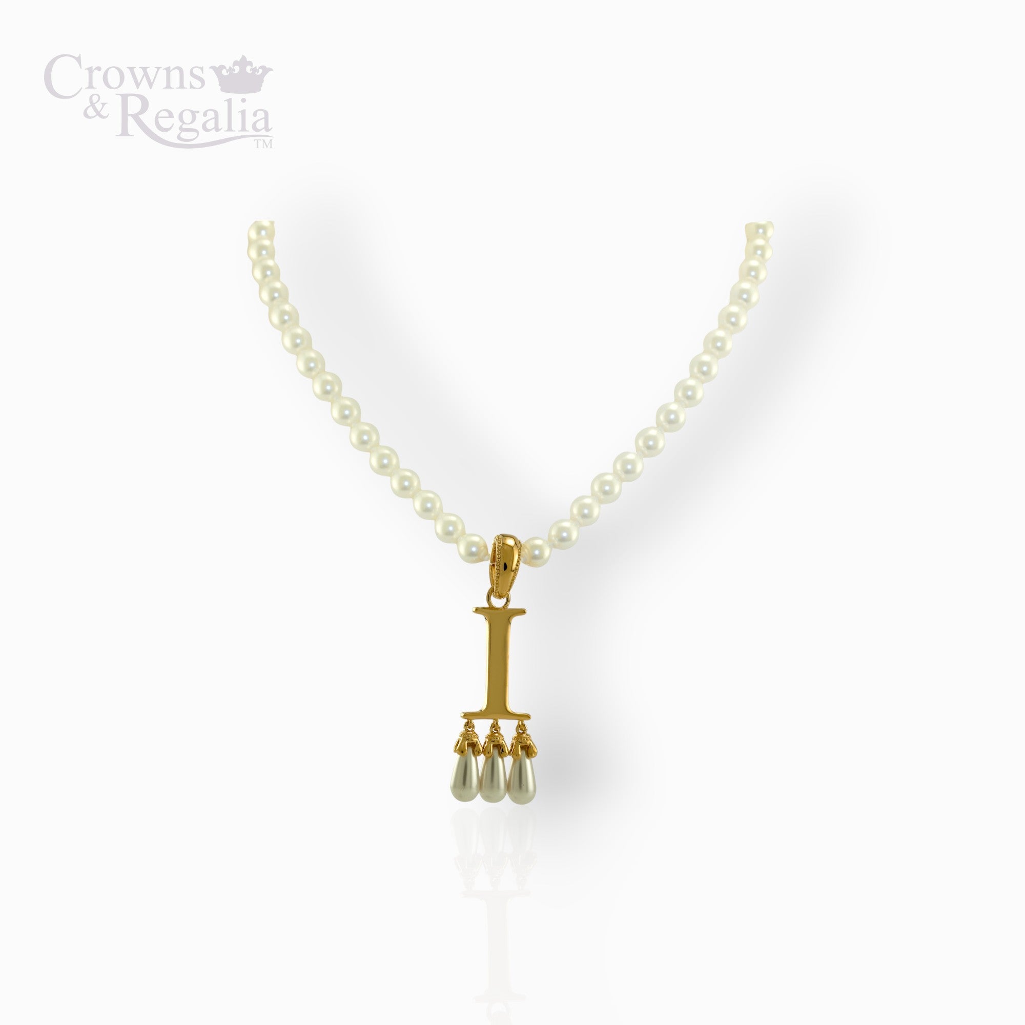 Pearl necklace with a gold pendant on a white background, featuring the brand 'Crowns & Regalia'.