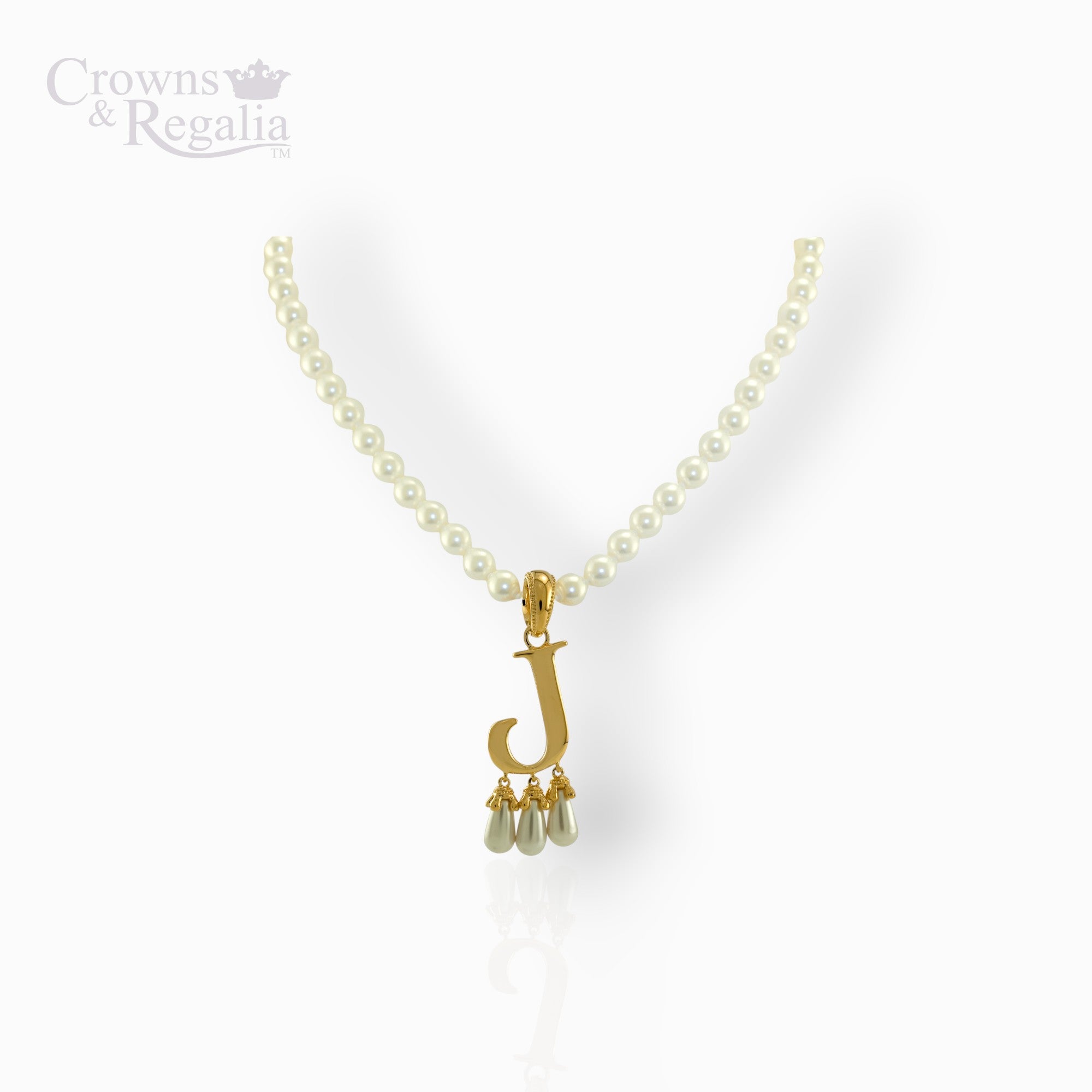 Pearl necklace with a gold pendant on a white background, featuring the brand 'Crowns & Regalia'.